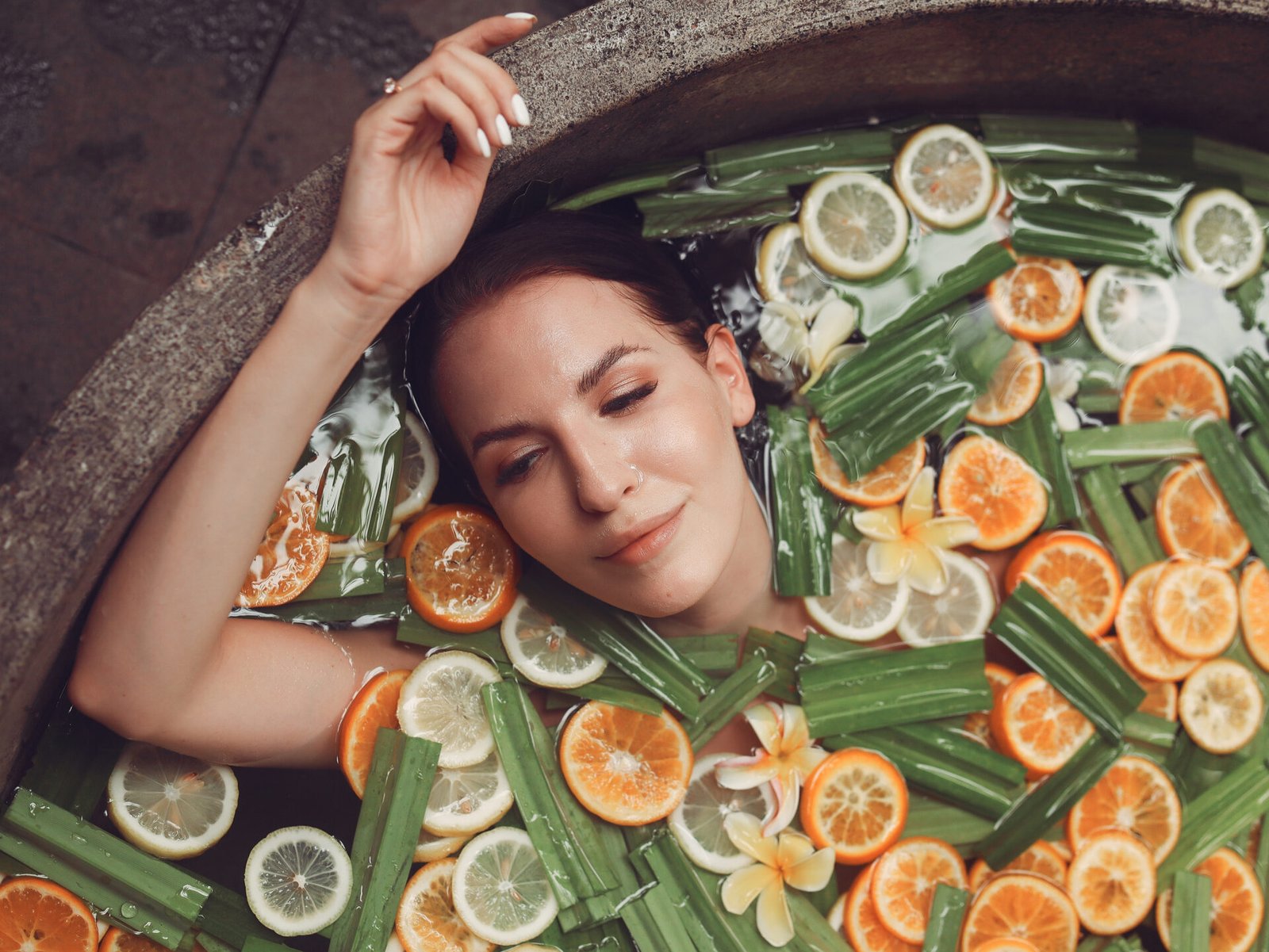 Girl in a bath. Lady on a Bali. Bath with fruits.